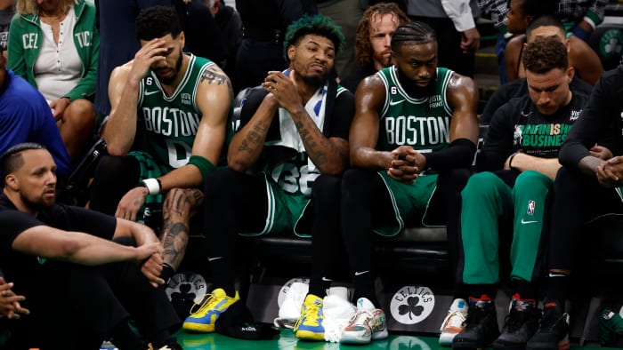 Boston Celtics forward Jayson Tatum, guard Marcus Smart and guard Jaylen Brown react from the bench during the fourth quarter against the Miami Heat in game seven of the Eastern Conference Finals.